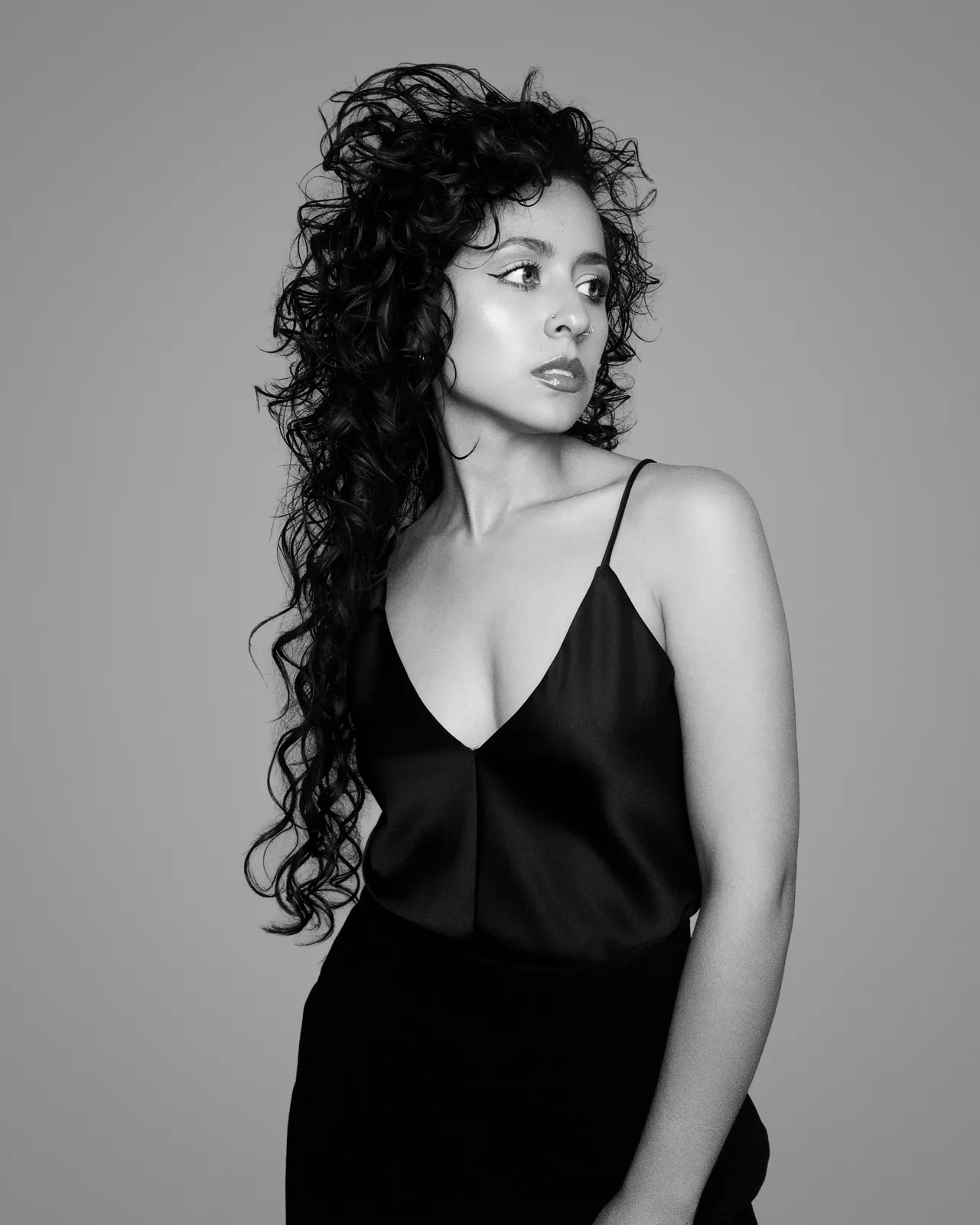 Paula in a black slip, looking to the left