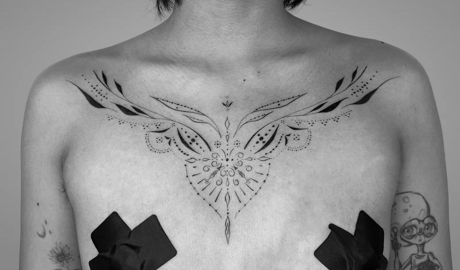 Ornamental tattoo across the chest