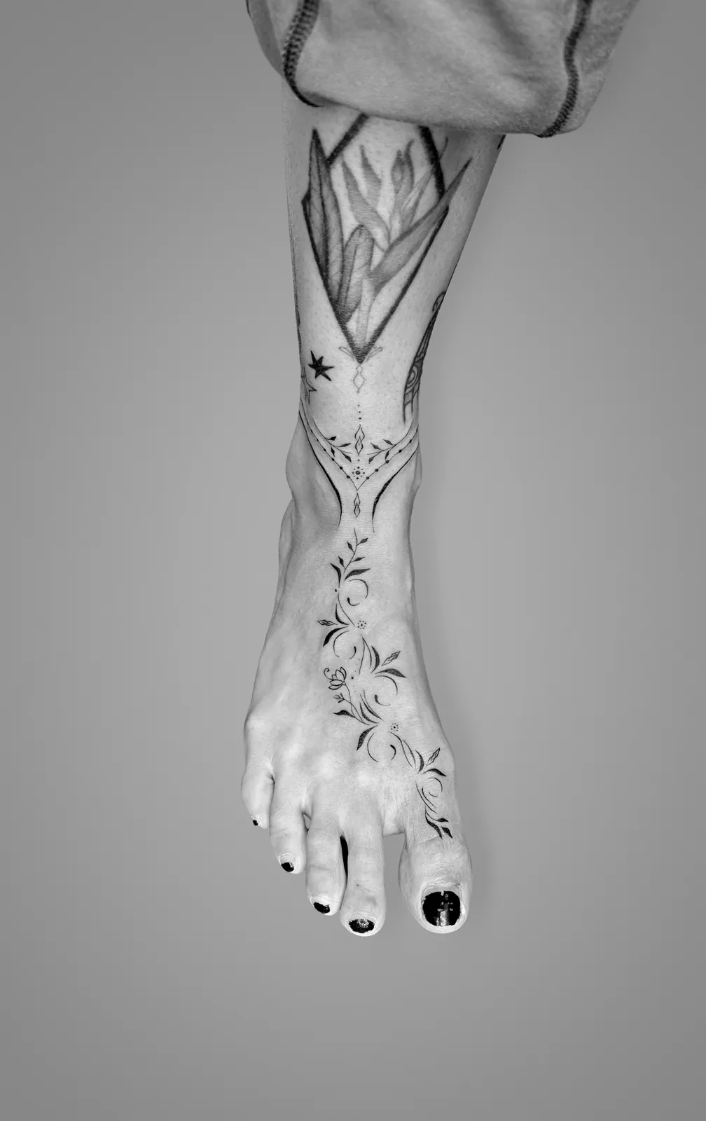Fine ornamental tattoo on a foot
