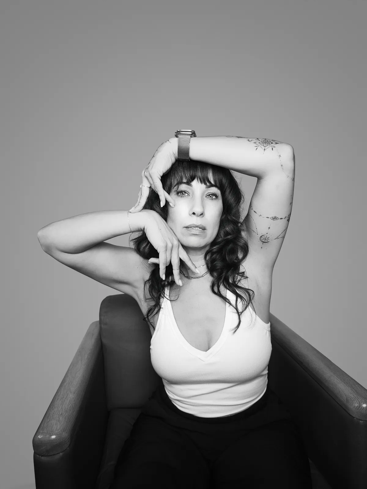 Studio portrait of a woman wearing her tattoos, photograph 5 of 16
