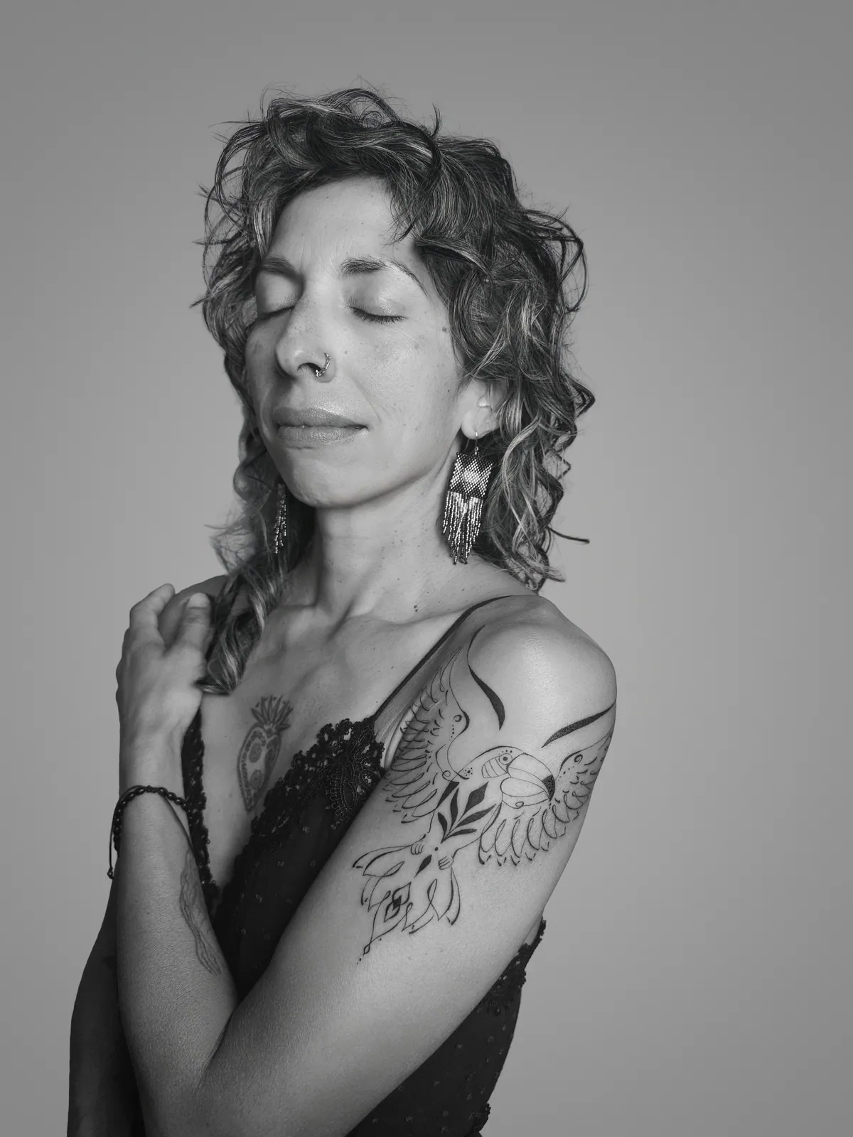 Studio portrait of a woman wearing her tattoos, photograph 12 of 16